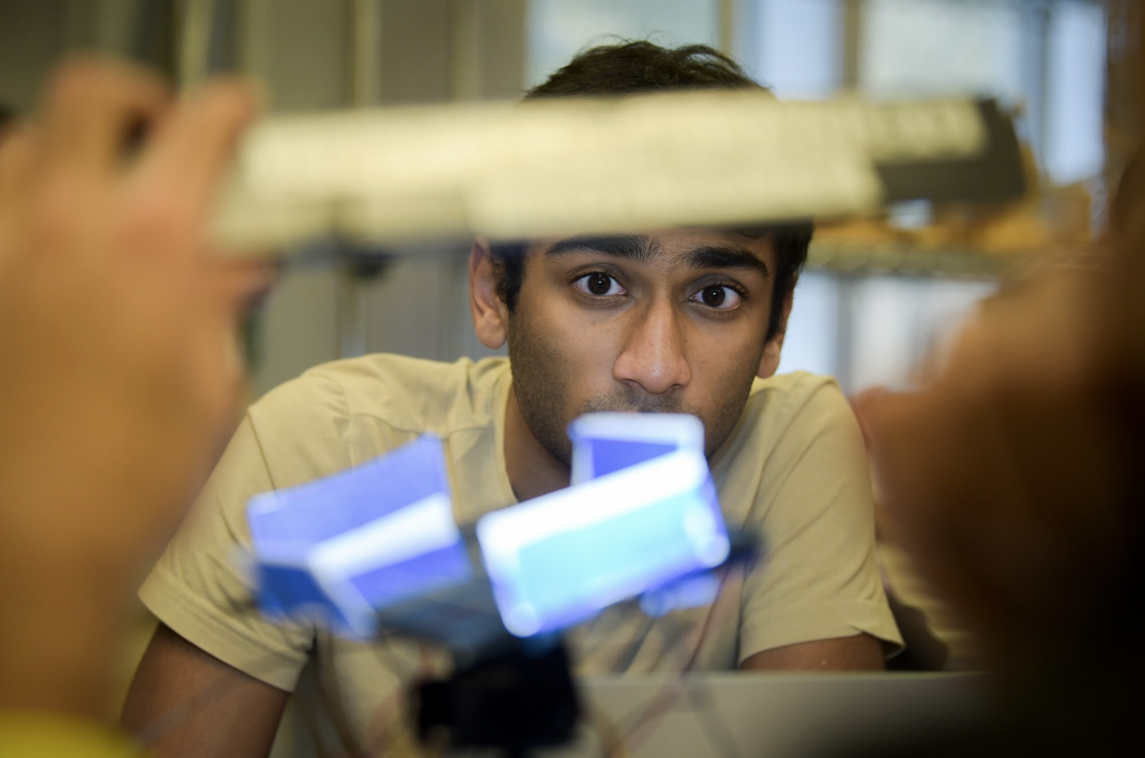 three students testing lab equipment